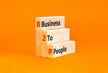 Naklejka premium B2P business to people symbol. Concept words B2P business to people on wooden blocks on a beautiful orange table orange background. Business and B2P business to people concept. Copy space.
