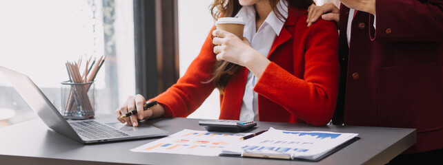Businessman and team analyzing financial statement Finance task. with smart phone and laptop and...