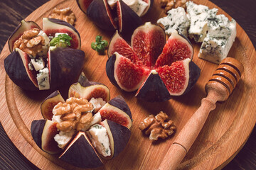 Appetizer, Figs with blue cheese, walnut, honey, on a wooden board, top view, close-up, no people,