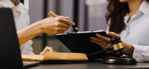 Male lawyer working with contract papers and wooden gavel on tabel in courtroom. justice and law ,attorney, court judge, concept.
