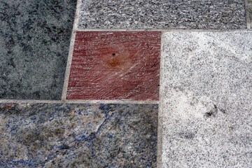 Close-up of colorful flagged floor with red, green, blue, black and white flagstones at City of Basel on a rainy autumn day. Photo taken October 3rd, 2022, Basel, Switzerland.