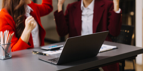 Businessman and team analyzing financial statement Finance task. with smart phone and laptop and...