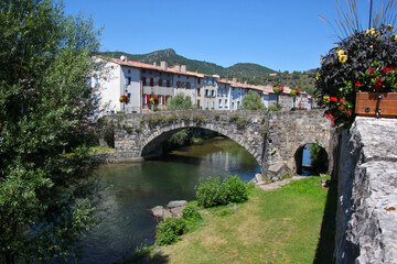 Fototapeta na wymiar Aude river cityscape with medieval stone bridge in the old town of Quillan, France