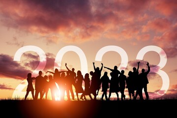 Silhouette of people jumping with 2023 numbers