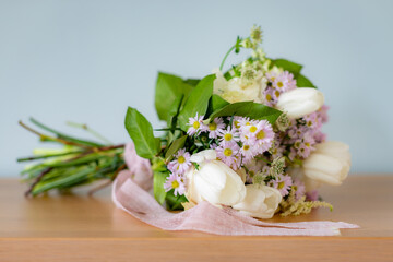 Elegant bouquet of spring flowers resting on a wooden table