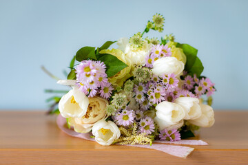 Elegant bouquet of spring flowers resting on a wooden table