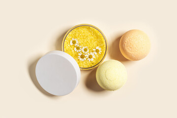 Top view bath bombs and sea salt with  herbal extract of chamomile, spa products close up. Natural cosmetic for beauty treatment and body care, home care, herbal medicine, beige background