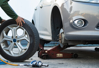 Mechanic repairing - replacing old tires