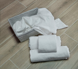 White terry towels in a gray basket