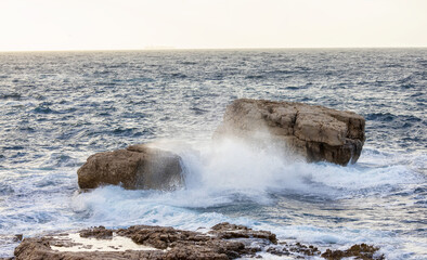 Rocky coast with waves on Mediterranean Sea. Italy, Europe. Nature Background.
