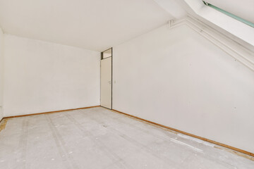 an empty room with white walls and wood trim on the floor, there is a door in the corner that leads...