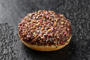 Sweet chocolate Donut with rainbow chippings. Sweet food.
