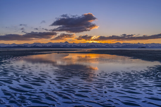 Tidal Flats at low tide at sunset with the Chilkat Mountains in the distance, Eagle Beach State Recreation Area, near Juneau; Alaska, United States of America