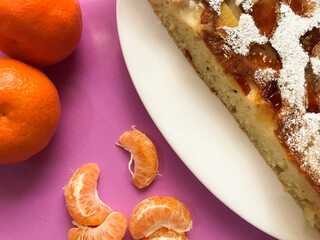 Baked apple pie with slices of tangerines for fasting