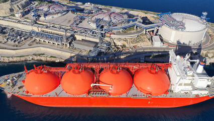 Aerial drone top down photo of LNG (Liquified Natural Gas) tanker anchored in small gas terminal...