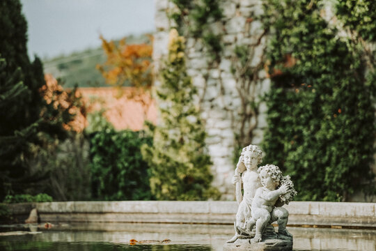 Sculpture in a pool in the garden of Duino Castle; Italy