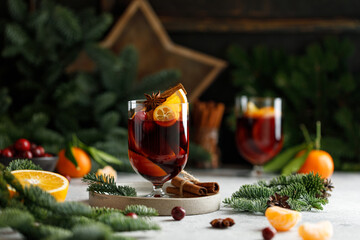 Christmas mulled wine on Christmas background. Hot Christmas beverage with orange and cranberry. 
