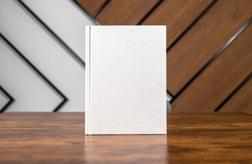 Blank book cover mockup, hardcover mock up of business literature on wood desk, office table