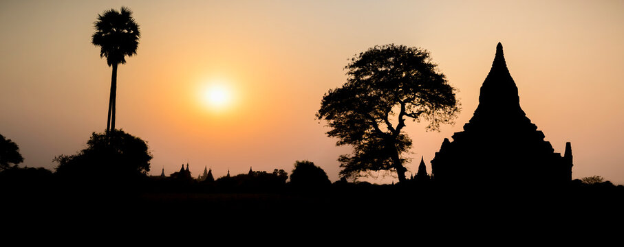 Silhouetted Buddhist temple at sunset; Bagan, Mandalay Region, Myanmar