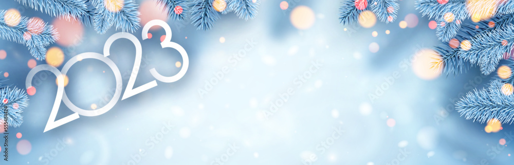 Poster 2023 sign with fir on blue background with yellow bokeh. space for text.