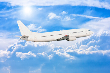 Fototapeta na wymiar White passenger aircraft fly in the picturesque sky