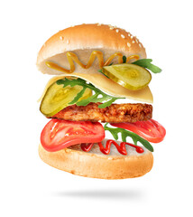 Food ingredients for a cheeseburger in the air isolated on a white background