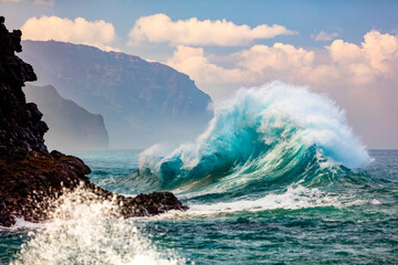 Large waves crash into the Na Pali coastline at Ke'e Beach; Kauai, Hawaii, United States of America