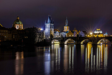 Fototapeta na wymiar Mystic Charles bridge at night and Vltava river in Prague