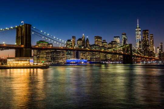 Manhattan skyline and Brooklyn Bridge at twilight, Brooklyn Bridge Park; Brooklyn, New York, United States of America