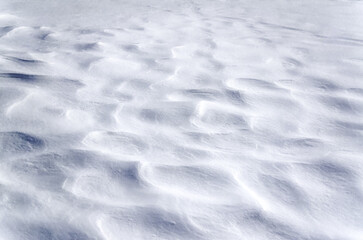 Texture of snow drifts close-up. Snow drifts, which appeared after snowfalls in the winter season.