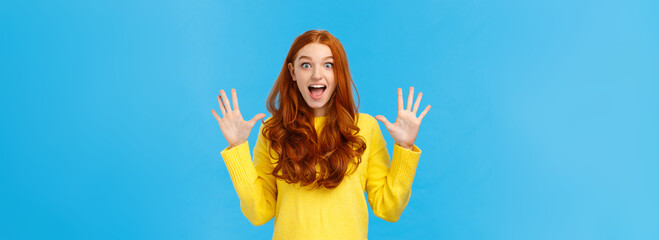 Excited, overwhelmed happy redhead cute girl in yellow sweater, screaming from joy telling about...