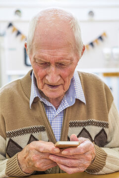 Senior man at the age of 97 with smart phone; Hartlepool, County Durham, England