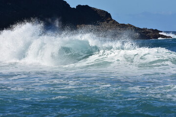 The blue of the  sea and the waves meet the horizon