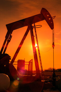 Pumpjack at sunset; Alberta, Canada