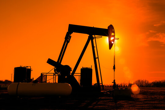 Pumpjack at sunset; Alberta, Canada