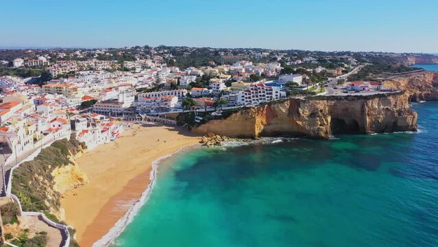 Beautiful aerial views of the seaside tourist town of Carvoeiro with cliff beaches and traditional Portuguese houses.