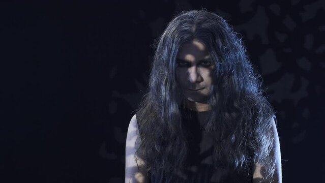 Man with goth lifestyle on black background. It's swinging.
The man who embraced darkness and pessimism.
