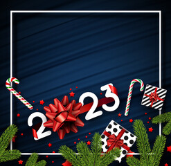 2023 sign with bow, gift boxes, candy canes, stars confetti on brush strokes background.