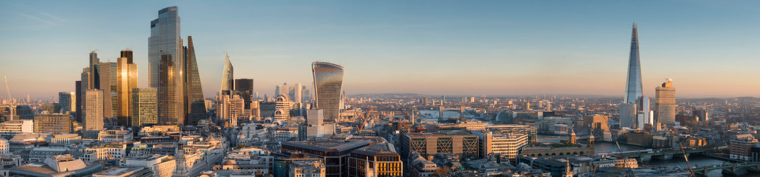 Panoramic cityscape and skyline of London with The Shard, 20 Fenchurch and various other skyscrapers at dusk; London, England