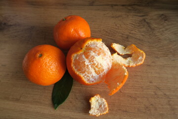 Mandarin slices on a wooden table with Christmas cones