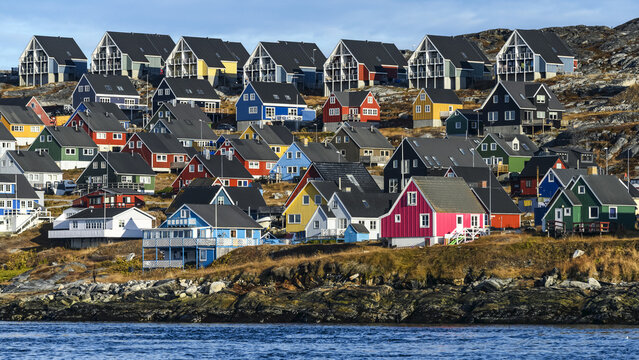Colourful houses along the rocky shore of Nuuk; Nuuk, Sermersooq, Greenland