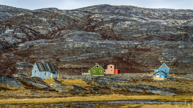 Colourful houses scattered on rocky landscape; Sermersooq, Greenland