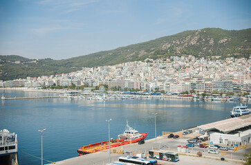 Fototapeta premium Kavala's picturesque harbor is a popular spot for boat rentals and sightseeing. Take a swim in one of Kavala's crystal-clear bays and cool off in the summer heat
