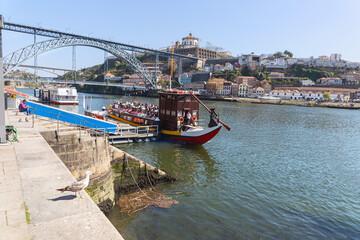 a small cruise liner with tourists is preparing to sail from the city pier. Travel concept. Porto....