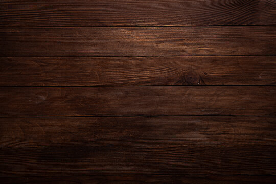 Vintage brown wood background texture with knots and nail holes. Old painted wood wall. Brown abstract background. Vintage wooden dark horizontal boards.