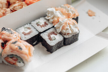Beautiful delicious sushi. Sushi delivery. Advertising sushi rolls made of fish and cheese.
