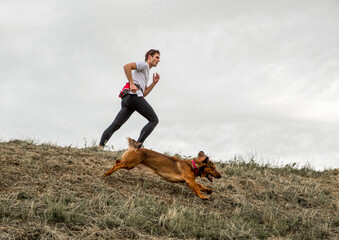 Fototapeta na wymiar Person running with the dog