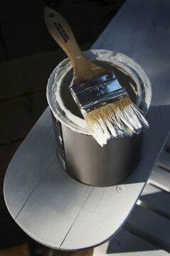 Can of White Primer Paint on Adirondack Chair
