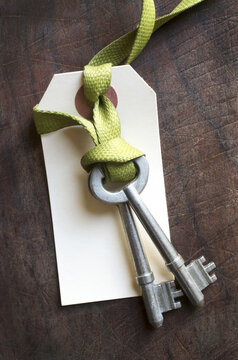 pair of skeleton keys with tag on a shoe lace