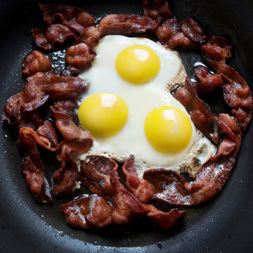 Greasy Frying Pan Full Of Bacon And Eggs